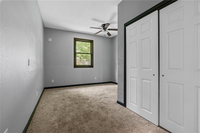 19707 E State Route A, Archie, MO 64725 - unfurnished bedroom featuring carpet floors, baseboards, a closet, and a ceiling fan
