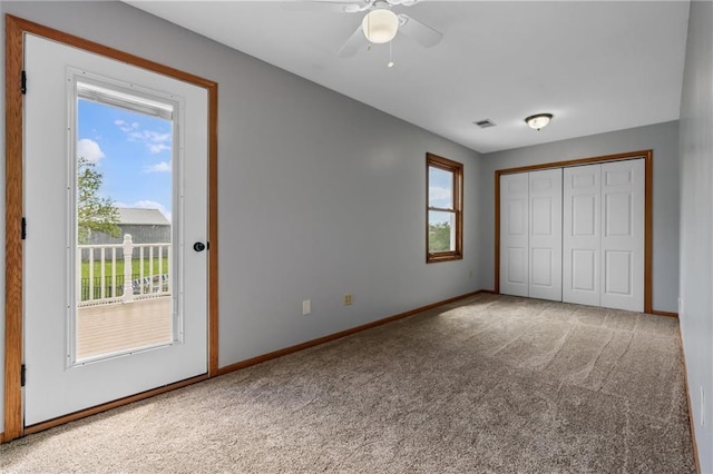 19707 E State Route A, Archie, MO 64725 - unfurnished bedroom featuring carpet, multiple windows, and access to outside