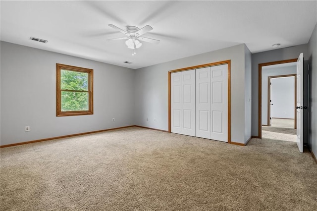 19707 E State Route A, Archie, MO 64725 - unfurnished bedroom with carpet, baseboards, a closet, and a ceiling fan
