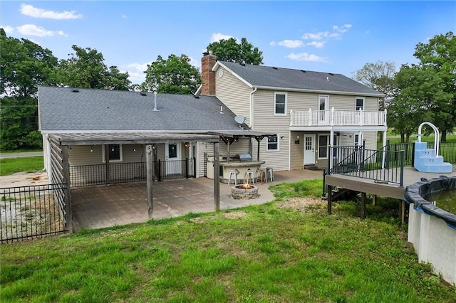 19707 E State Route A, Archie, MO 64725 - rear view of house with a patio area, an outdoor fire pit, exterior kitchen, a deck, and a balcony