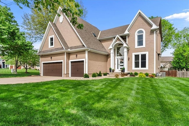 view of front of house featuring a front lawn, fence, a shingled roof, concrete driveway, and an attached garage