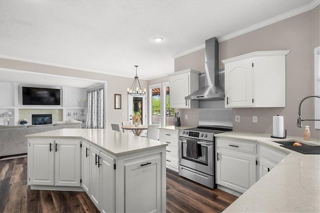 kitchen with wall chimney range hood, dark wood-style flooring, crown molding, stainless steel range with electric cooktop, and a sink