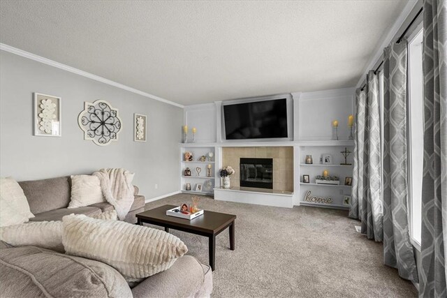 living room with a textured ceiling, crown molding, built in features, a fireplace, and carpet flooring