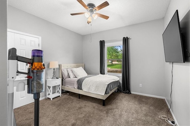 bedroom featuring carpet floors, a textured ceiling, baseboards, and ceiling fan