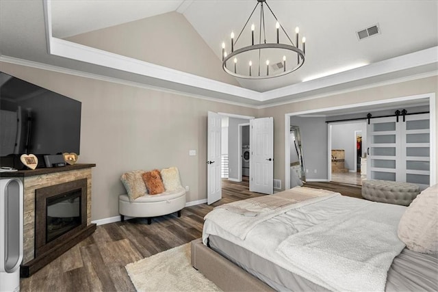 bedroom featuring an inviting chandelier, a premium fireplace, high vaulted ceiling, wood finished floors, and visible vents