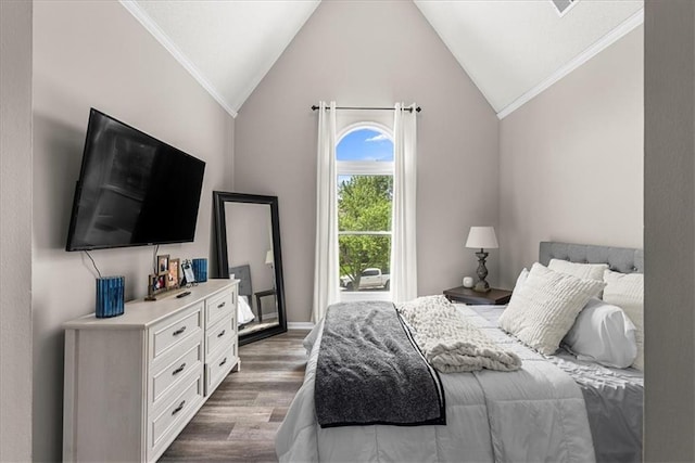 bedroom with ornamental molding, lofted ceiling, and wood finished floors