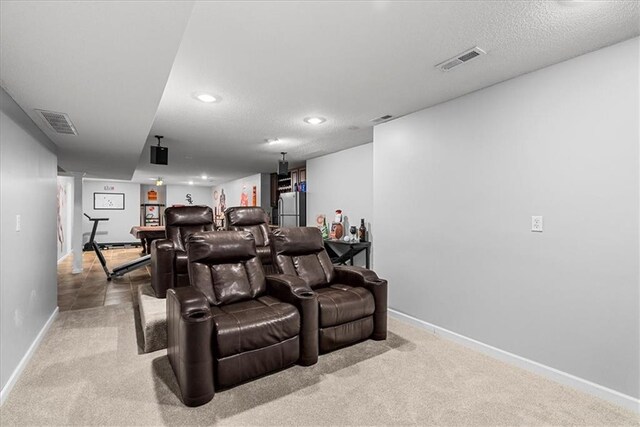 carpeted home theater featuring recessed lighting, baseboards, visible vents, and a textured ceiling