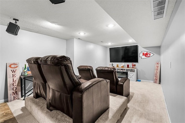cinema with baseboards, recessed lighting, a textured ceiling, and visible vents