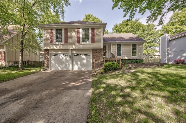 split level home featuring concrete driveway, an attached garage, and brick siding