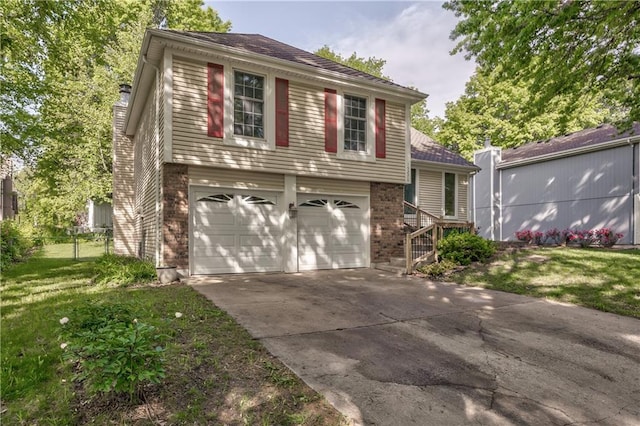 tri-level home featuring an attached garage, brick siding, concrete driveway, and a chimney