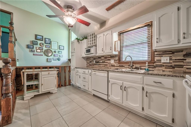 kitchen featuring white appliances, a sink, white cabinetry, ceiling fan, and tasteful backsplash