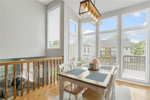 sunroom / solarium featuring an inviting chandelier