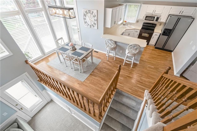 dining room with light wood-style floors and baseboards