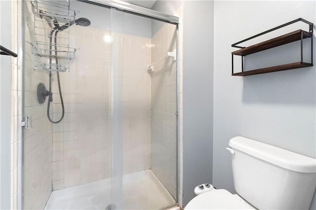 full bath featuring toilet and a shower stall