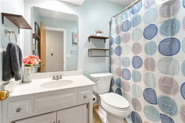 full bathroom with vanity, curtained shower, and toilet