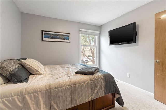 carpeted bedroom featuring baseboards