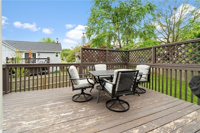 wooden deck with outdoor dining area