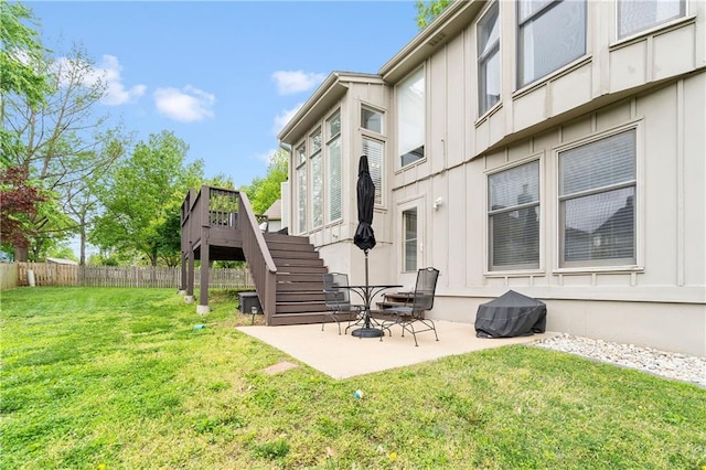 view of yard featuring stairway, fence, a wooden deck, and a patio area