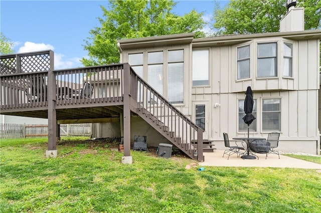 back of house featuring a patio, board and batten siding, stairs, and a deck