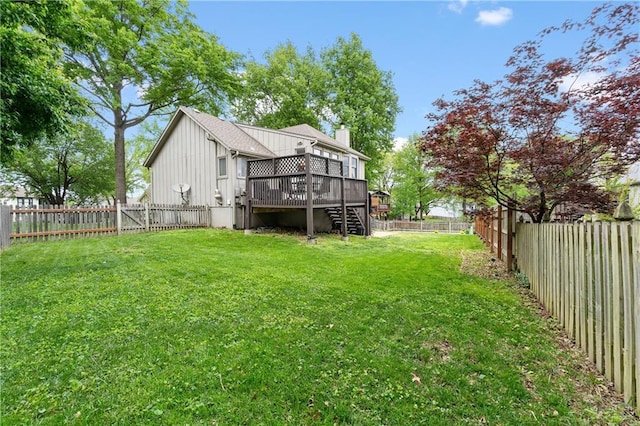 view of yard with stairs, a fenced backyard, and a wooden deck