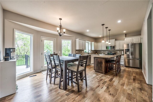 dining room featuring recessed lighting, visible vents, and light wood-style flooring