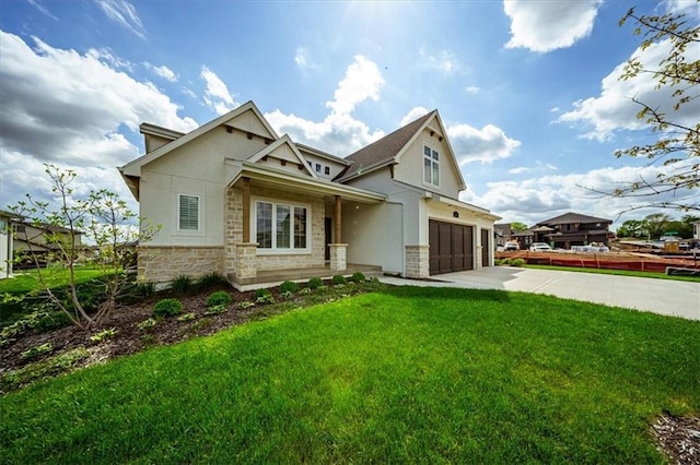 craftsman inspired home with a front lawn, stucco siding, driveway, and stone siding