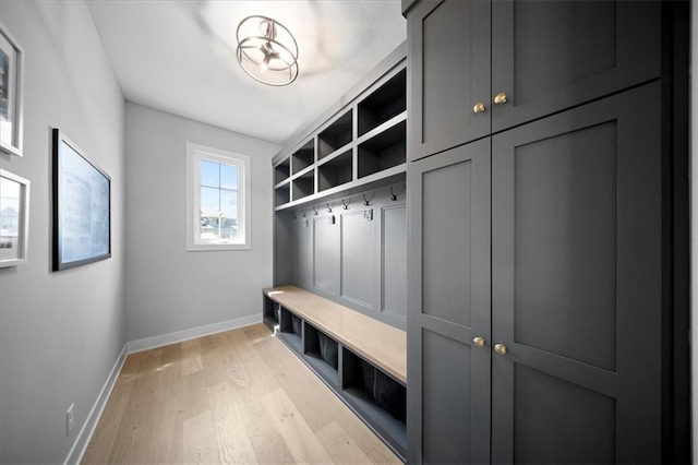 mudroom with baseboards and light wood-style flooring