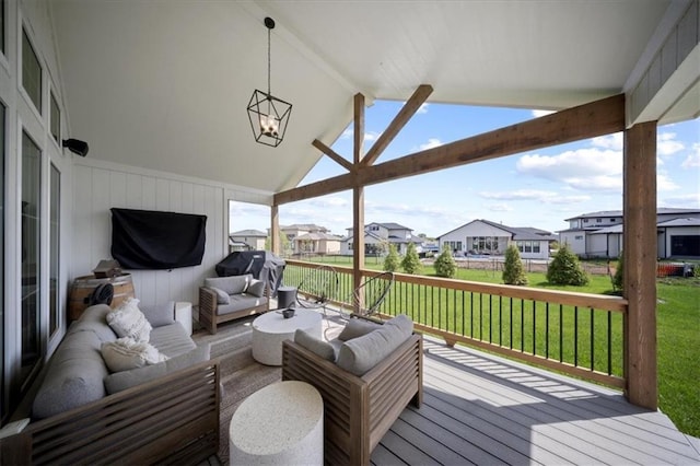 wooden terrace with a yard, outdoor lounge area, and a residential view