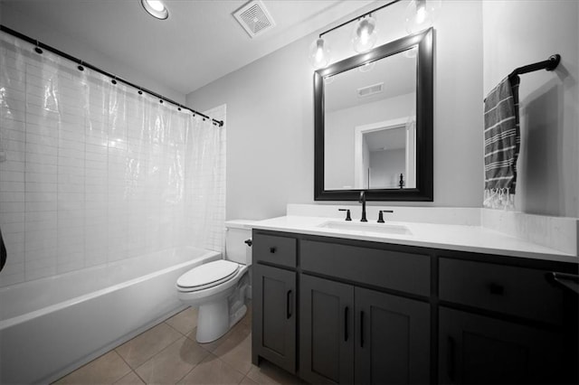 bathroom with toilet, tile patterned floors, visible vents, and vanity