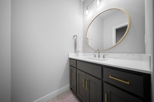 bathroom featuring tile patterned floors, baseboards, and vanity