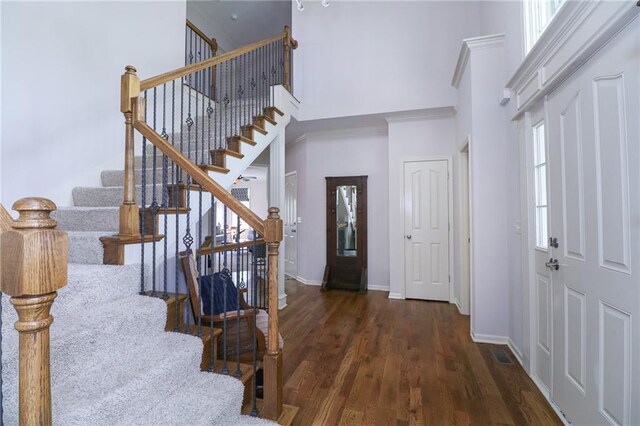 17065 W 162nd St, Olathe, KS 66062 - foyer featuring visible vents, a towering ceiling, wood finished floors, baseboards, and stairs