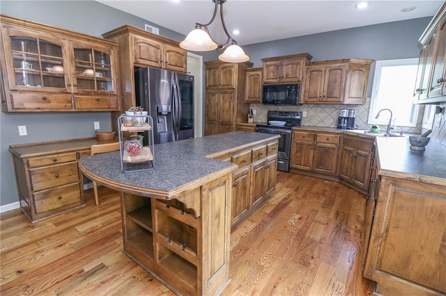 17065 W 162nd St, Olathe, KS 66062 - kitchen with dark countertops, a center island, open shelves, a sink, and stainless steel appliances