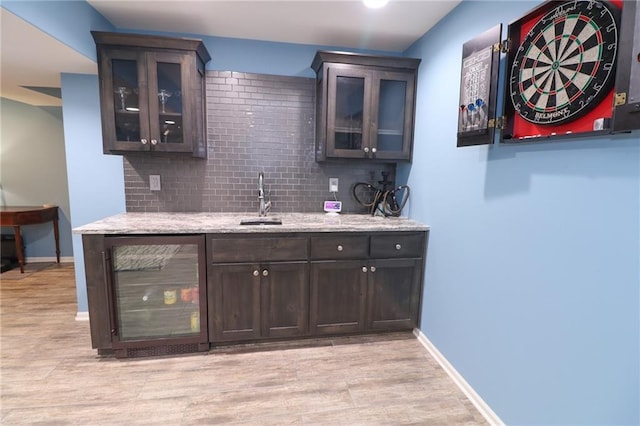 17065 W 162nd St, Olathe, KS 66062 - bar with beverage cooler, a sink, light wood finished floors, and tasteful backsplash