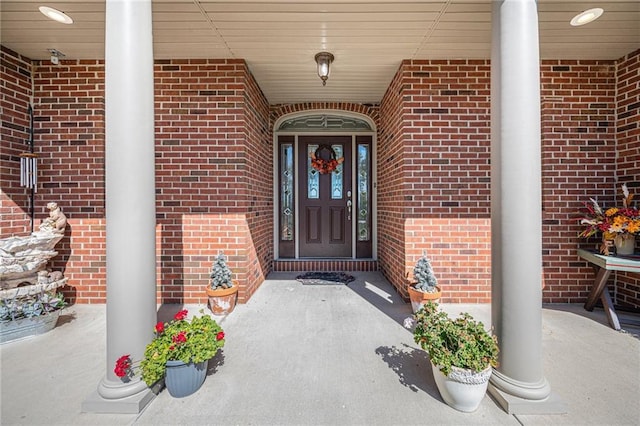 property entrance featuring brick siding