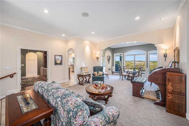 carpeted living room featuring crown molding, arched walkways, baseboards, and recessed lighting