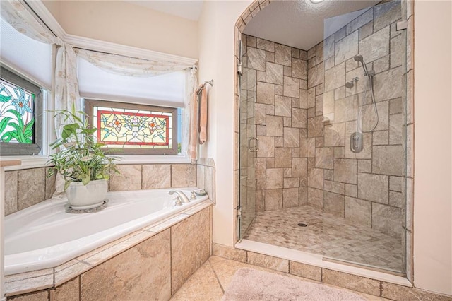 full bathroom with a shower stall and a garden tub