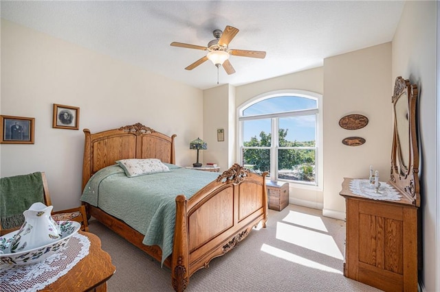 bedroom with a ceiling fan and light colored carpet
