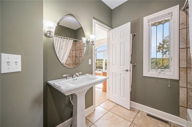 bathroom featuring visible vents, baseboards, tile patterned flooring, and a shower with curtain