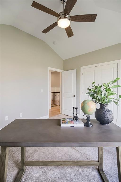home office featuring a ceiling fan, wood finished floors, and lofted ceiling