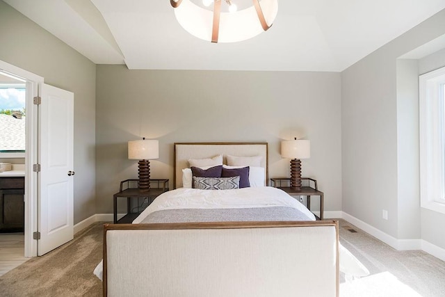 bedroom featuring baseboards, light carpet, and multiple windows
