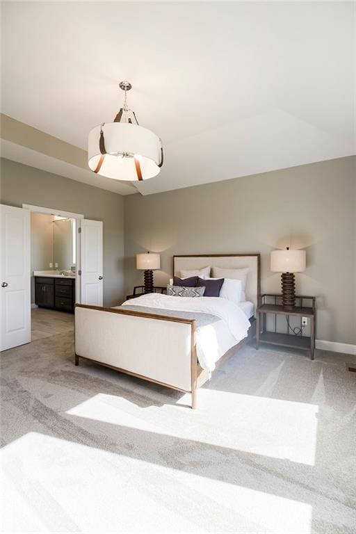 bedroom with baseboards and light carpet