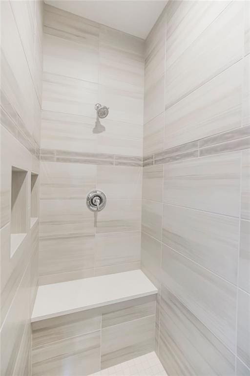 bathroom with tiled shower