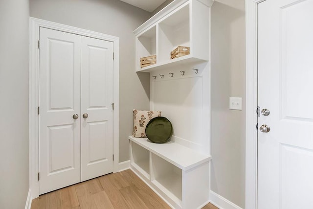 mudroom with baseboards and light wood finished floors