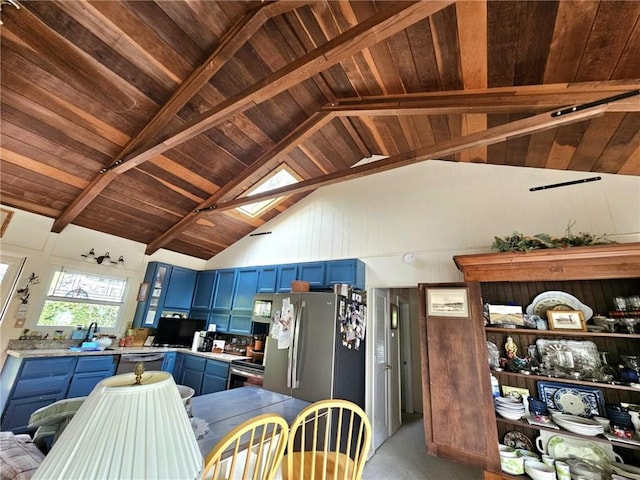 kitchen with blue cabinetry, appliances with stainless steel finishes, light countertops, wooden ceiling, and high vaulted ceiling