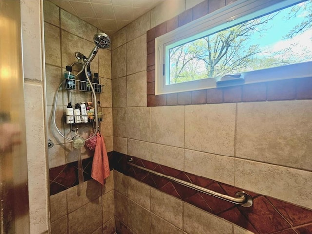 bathroom with a tile shower