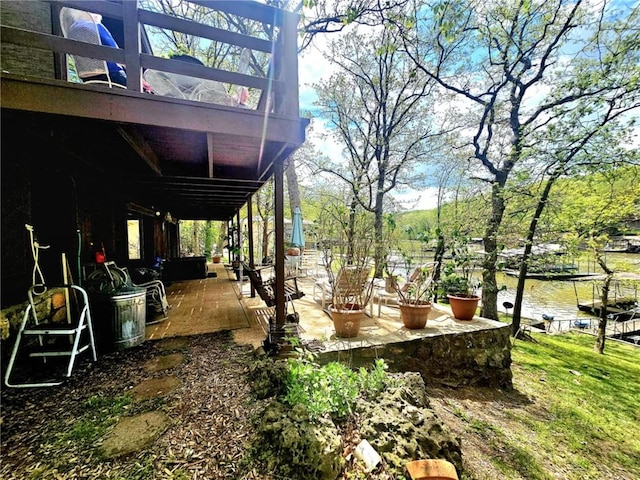 view of yard with a water view and a patio area