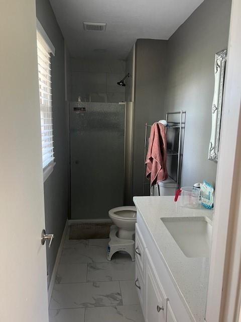 full bathroom with vanity, toilet, marble finish floor, visible vents, and a stall shower