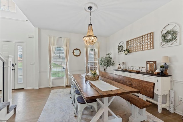 dining room with baseboards, a chandelier, and wood finished floors