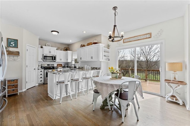 dining room featuring recessed lighting, a chandelier, and hardwood / wood-style floors