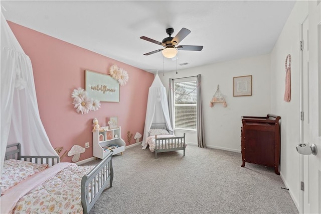 carpeted bedroom with baseboards, visible vents, and ceiling fan